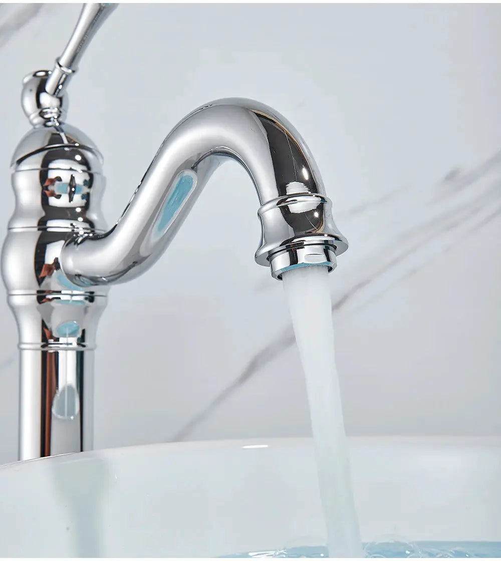 Chrome vessel basin faucet, deck-mounted single-hole mixer with curved spout and water flowing into the sink
