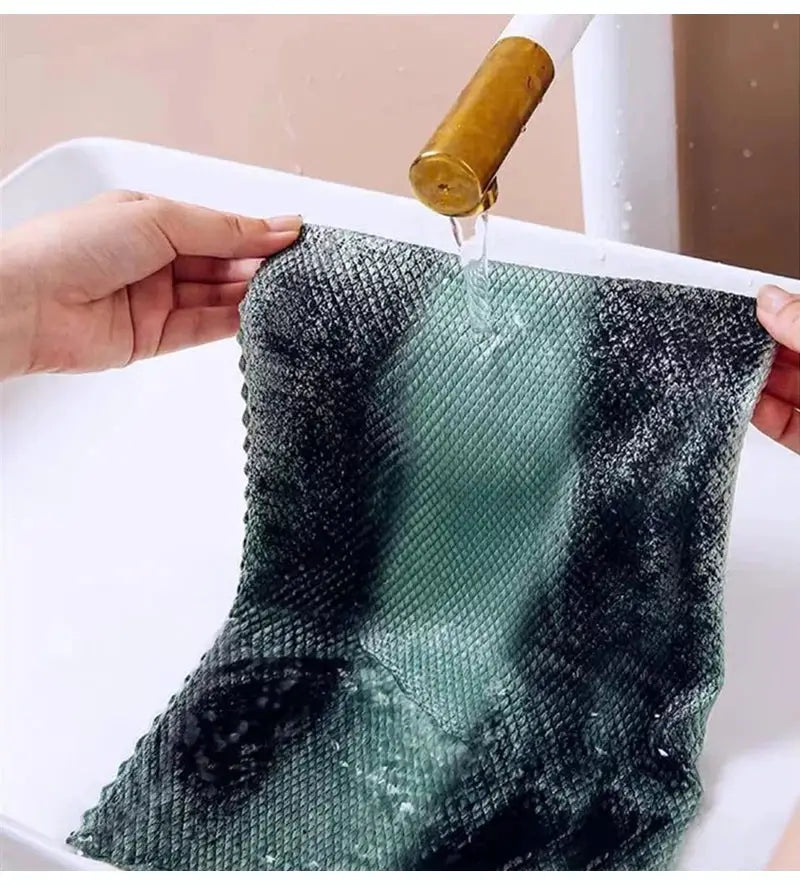 Teal microfiber dish cloth being rinsed under running water