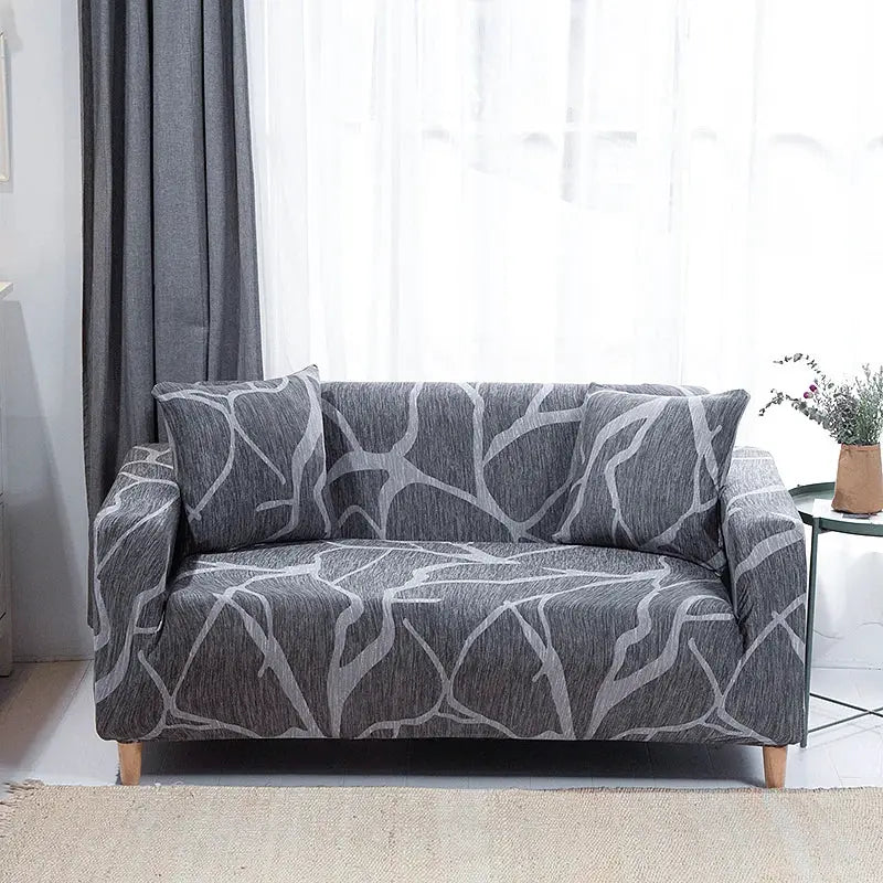 Sofa slipcover for living room; grey stretch fabric with white branch pattern on a 2-seat sofa.