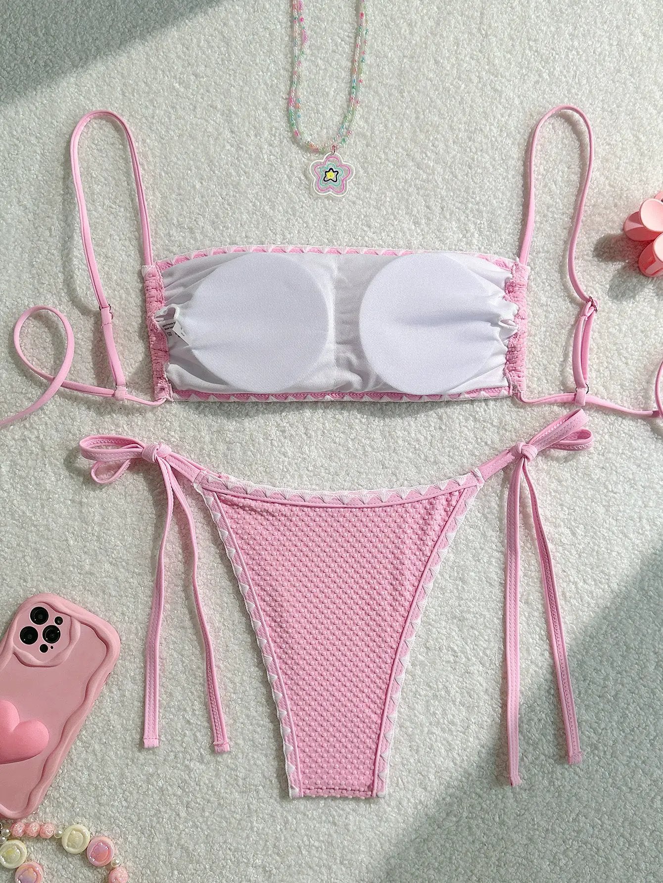 Two-piece bikini set: white bandeau top with pink trim and pink tie-side bottoms
