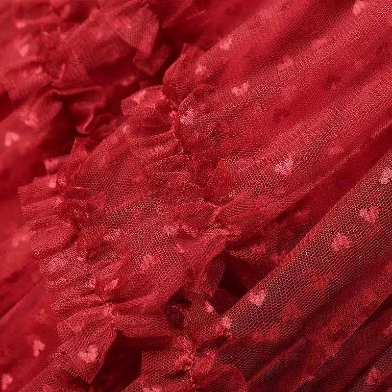 Red mesh heart-printed tulle skirt by Simples Market with elastic high waist and ruffle detail