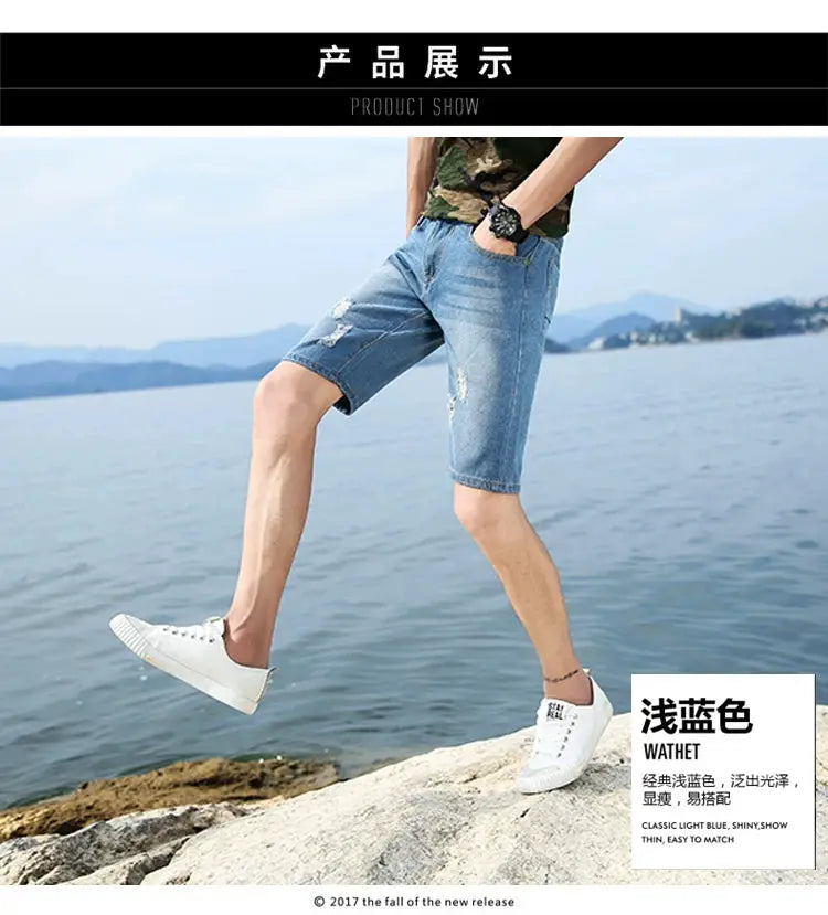 Men's light blue denim shorts with distressed rips, knee-length casual wear.
