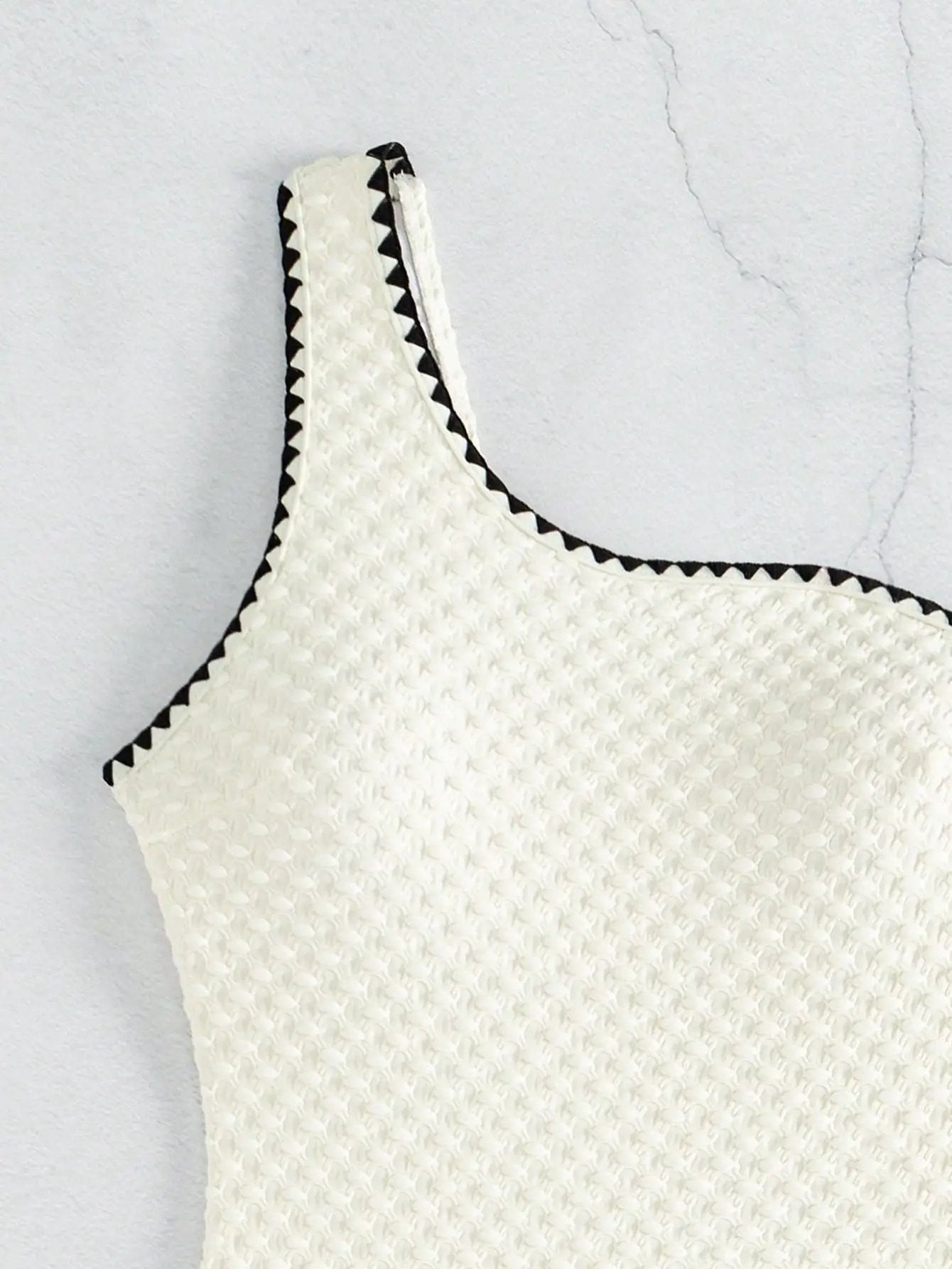 White textured strapless bikini top with black zigzag trim