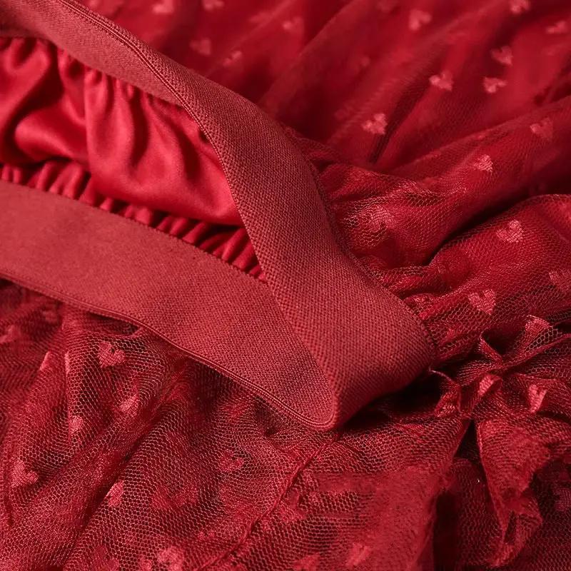 Red mesh heart-printed skirt close-up with elastic waistband and tulle fabric