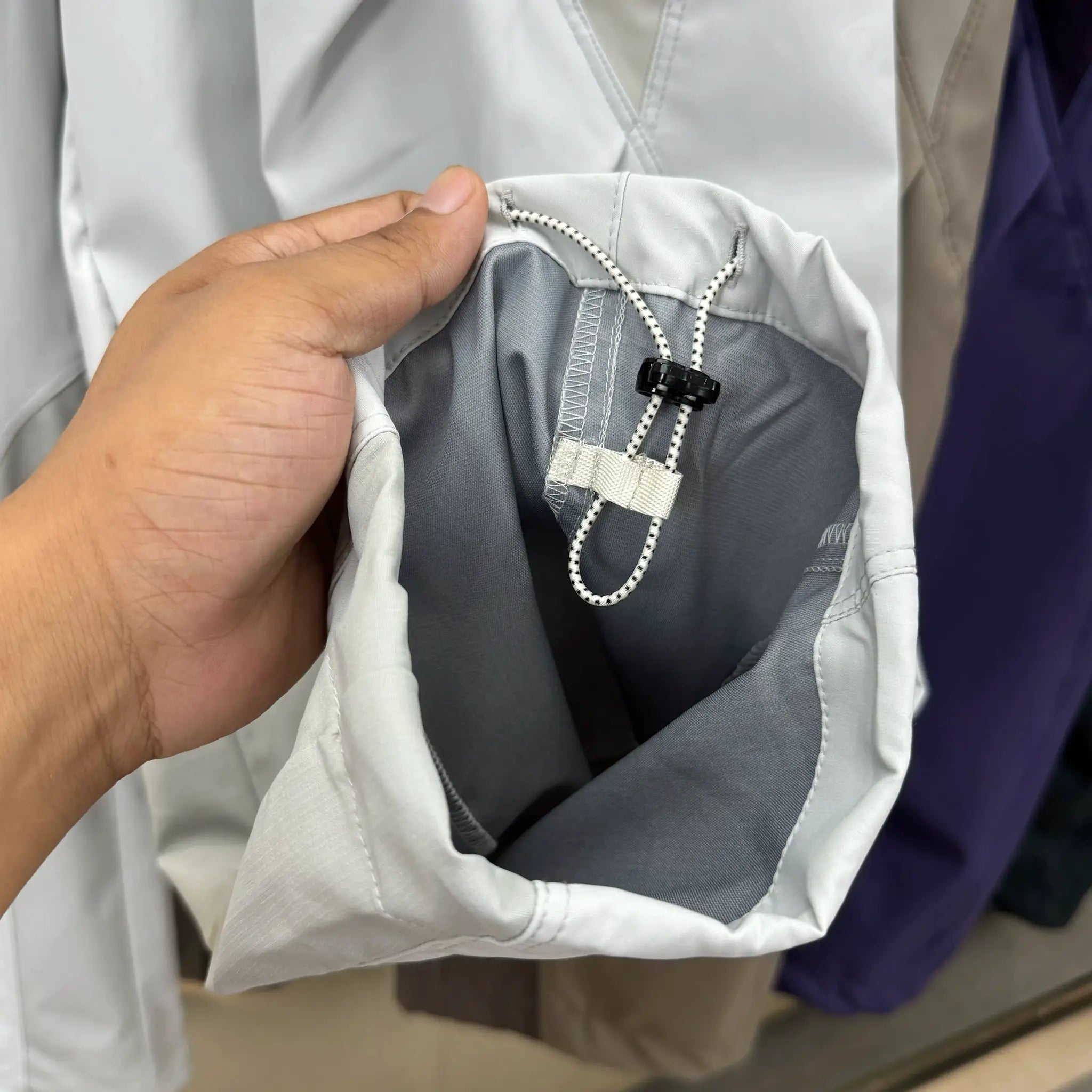 Light gray cargo pants with black and white drawstring waistband