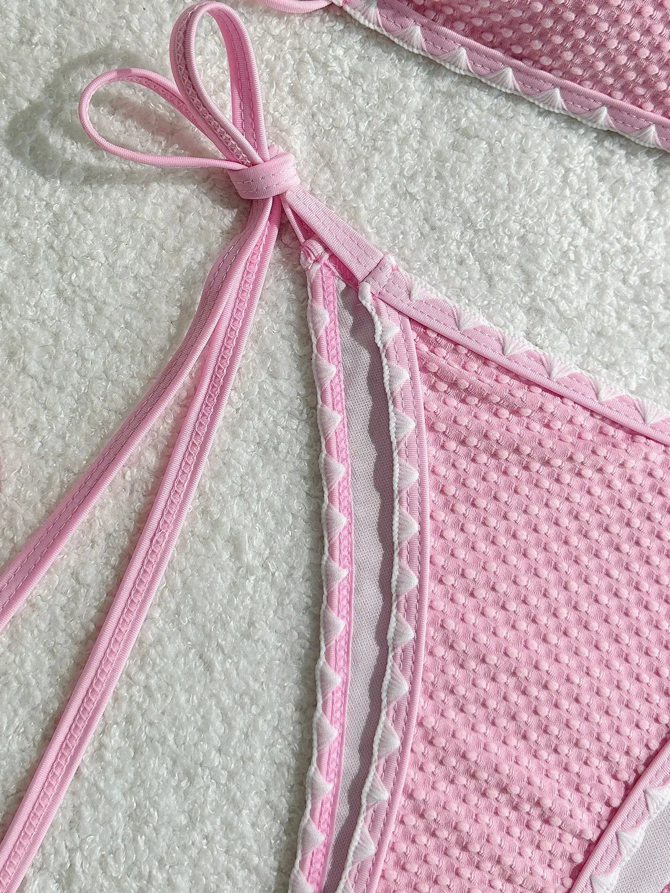 Simples Market pink textured two-piece swimsuit with tie straps and white triangle trim