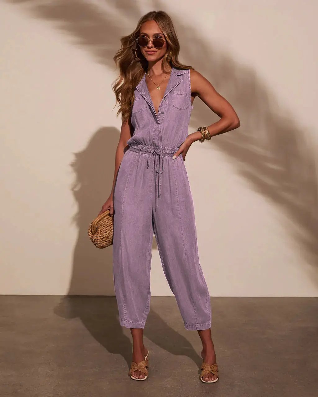 Women's lavender denim jumpsuit with sleeveless top, drawstring waist and pockets