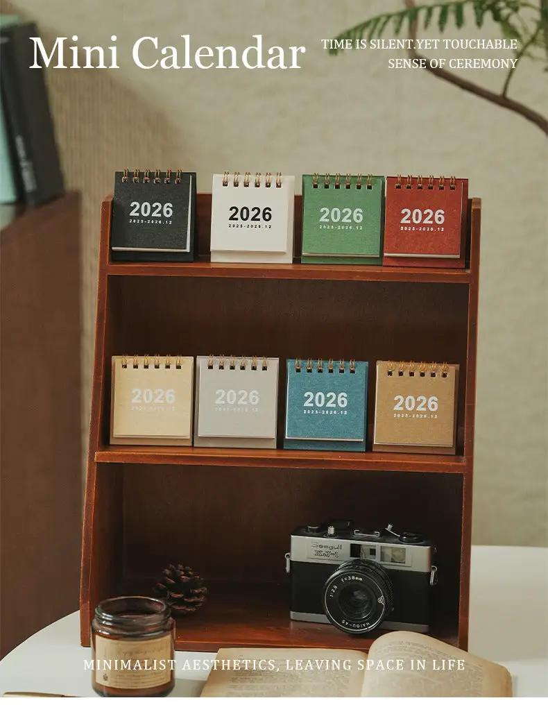 Mini calendar set on a wooden shelf; 2026 coil desk calendars in assorted colors