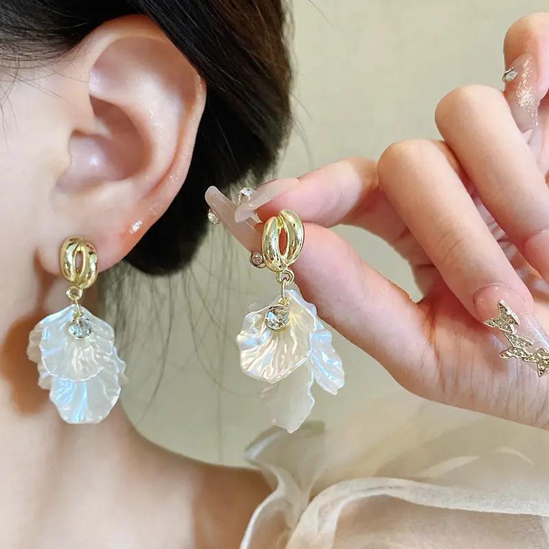 Glossy shell flower pendant earrings - a pair by Simples Market - gold-tone hoops with translucent petals and crystals