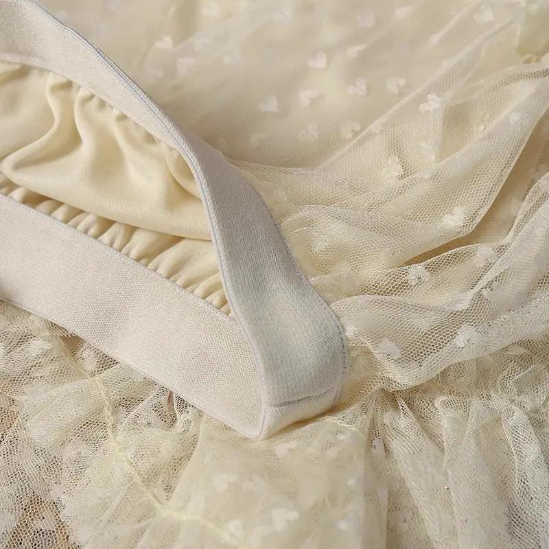 Women's cream mesh heart-printed skirt with elastic high waist and delicate tulle A-line silhouette.