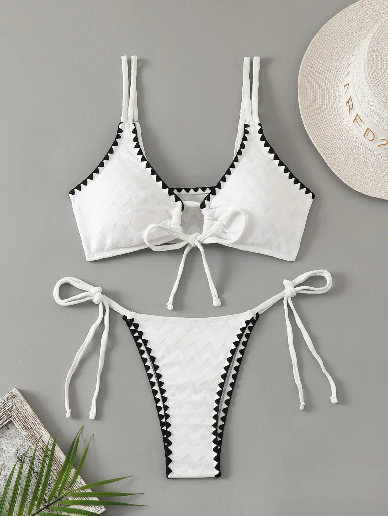 Simples Market white 2-piece bikini set with textured chevron fabric, black trim, tie-front top and side-tie bottoms.