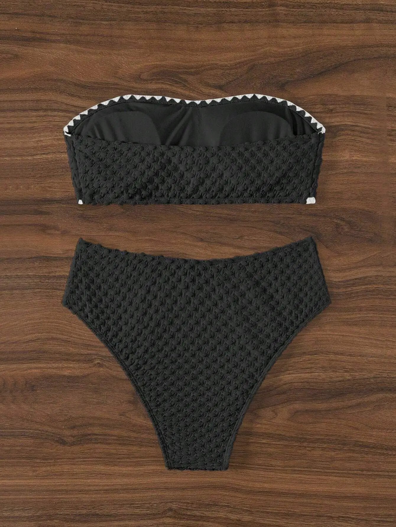 Black textured 2-piece strapless bikini set with white trim, bandeau top and matching bottoms.