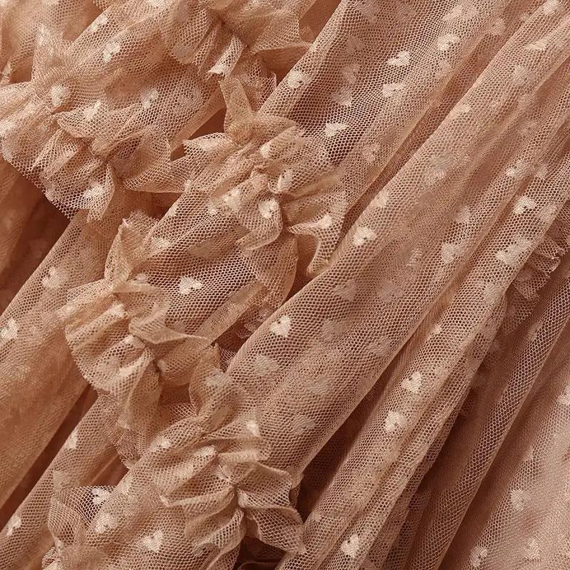 Skirt peach mesh heart print; close-up of tulle mesh with small hearts and ruffles