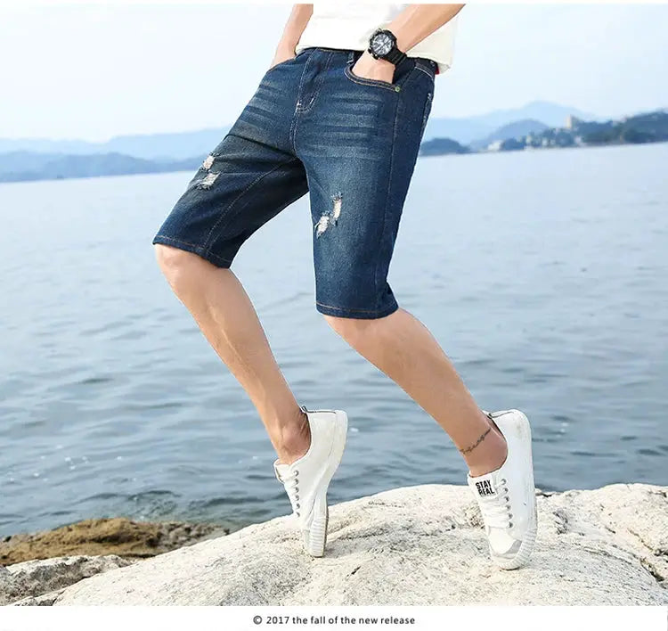 Men's blue denim shorts by Simples Market, distressed knee-length casual wear.