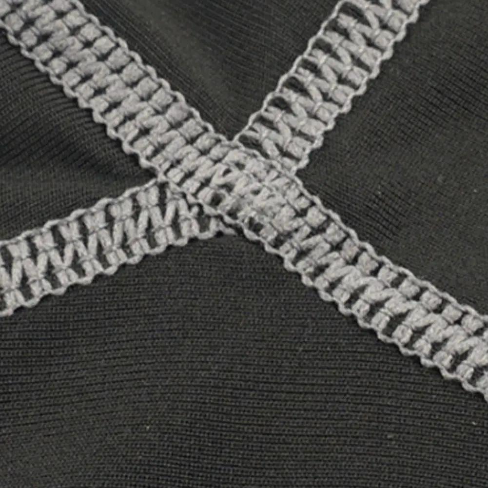 Men's compression shorts close-up of black fabric with gray cross-stitch seams
