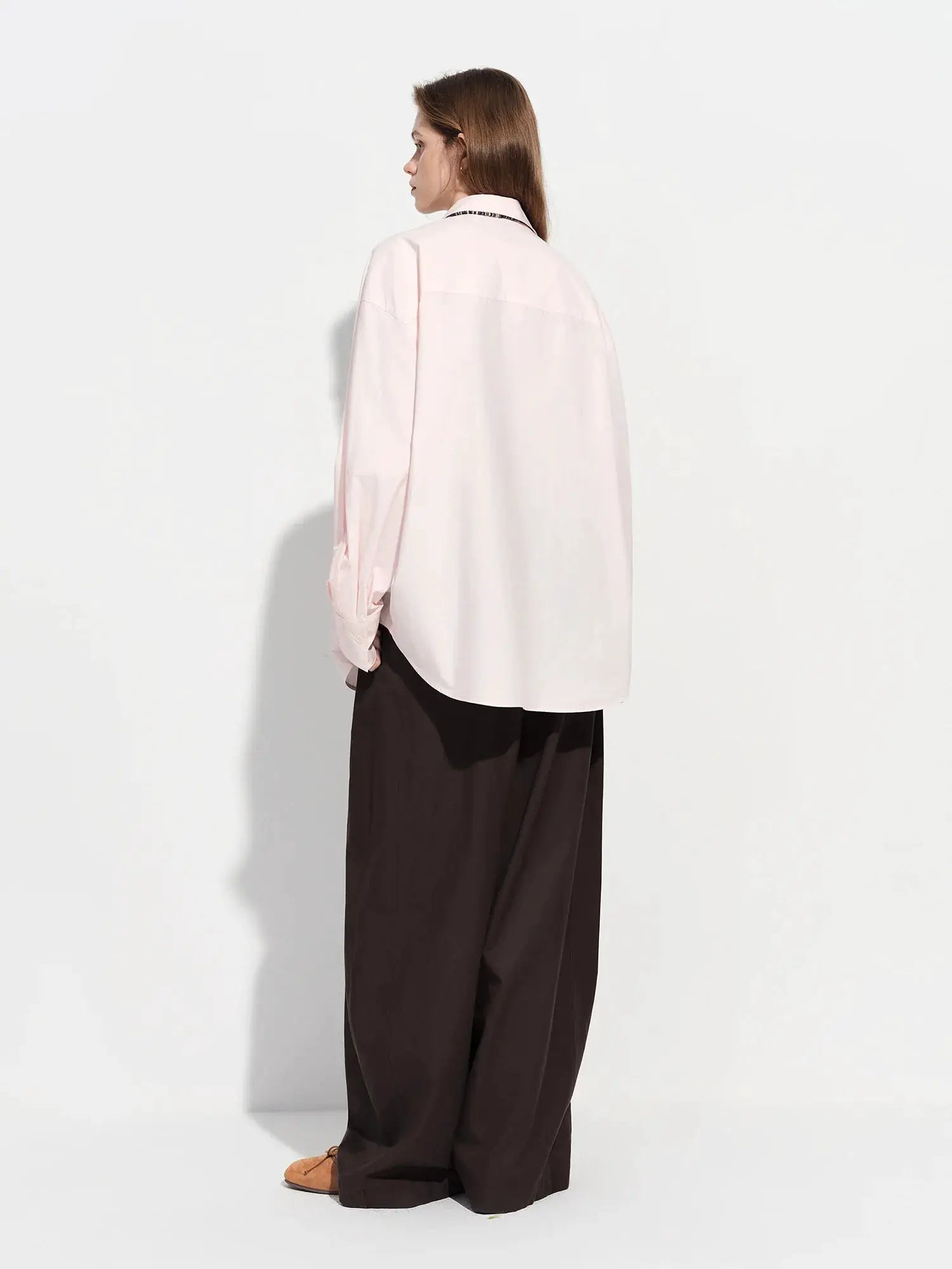 Women's pale pink cotton shirt, oversized loose-fit with long sleeves and web strap detail.