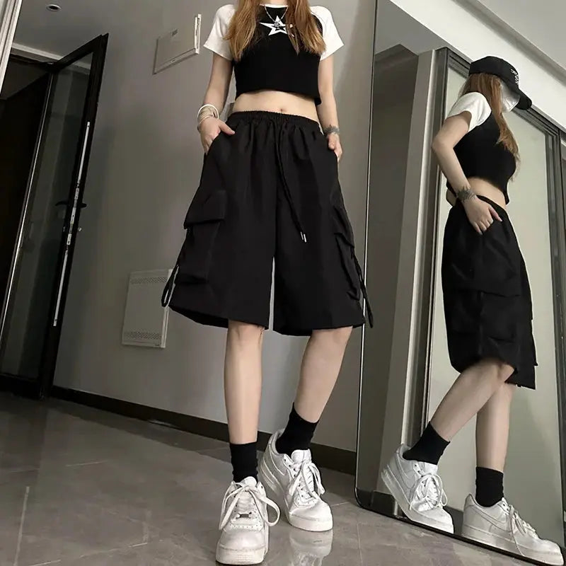 ZOKI women high-waist cargo shorts, black wide-leg with large pockets for streetwear.