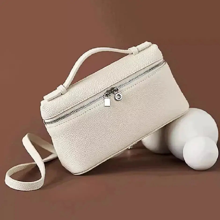 Mini lychee-grain shoulder bag in cream with top handle, detachable crossbody strap and silver zip.