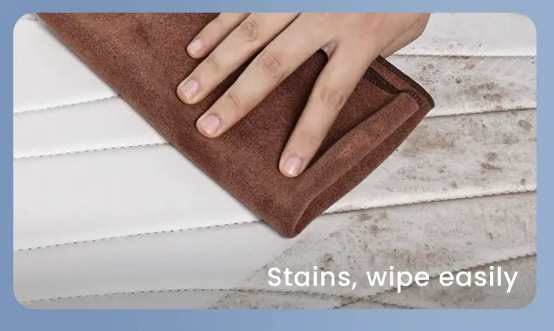 Tesla Model Y leather trunk mats by Simples Market; white mat being wiped with brown cloth to remove stains
