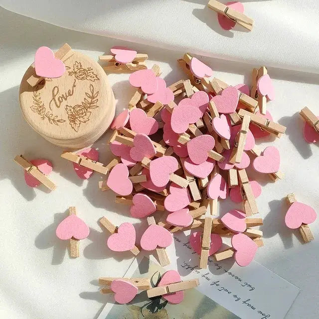 Heart-shaped wooden clothespins, 50pcs, pink, for photo displays and craft decor.