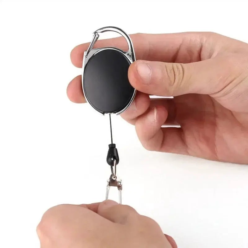Retractable badge reel key chain holder, black circular reel with quick-release clip by Simples Market