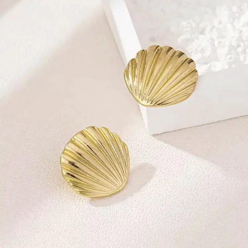 Gold-tone ocean shell texture stud earrings by Simples Market, for women, pair