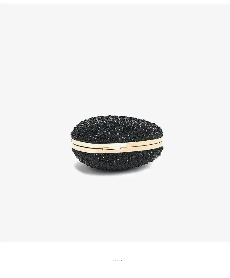 Heart-shaped crystal clutch purse in black rhinestones with a gold-tone frame.