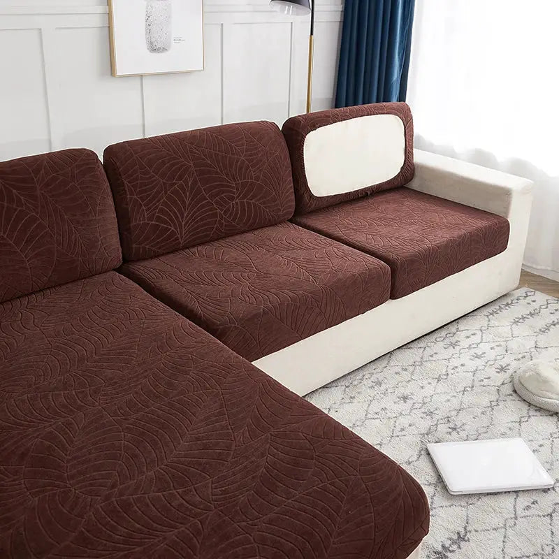 Waterproof stretch couch cushion cover by Simples Market in brown leaf-pattern on a beige sectional.