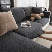 Sofa cover by Simples Market in dark gray teddy fleece; non-slip elastic seat protector