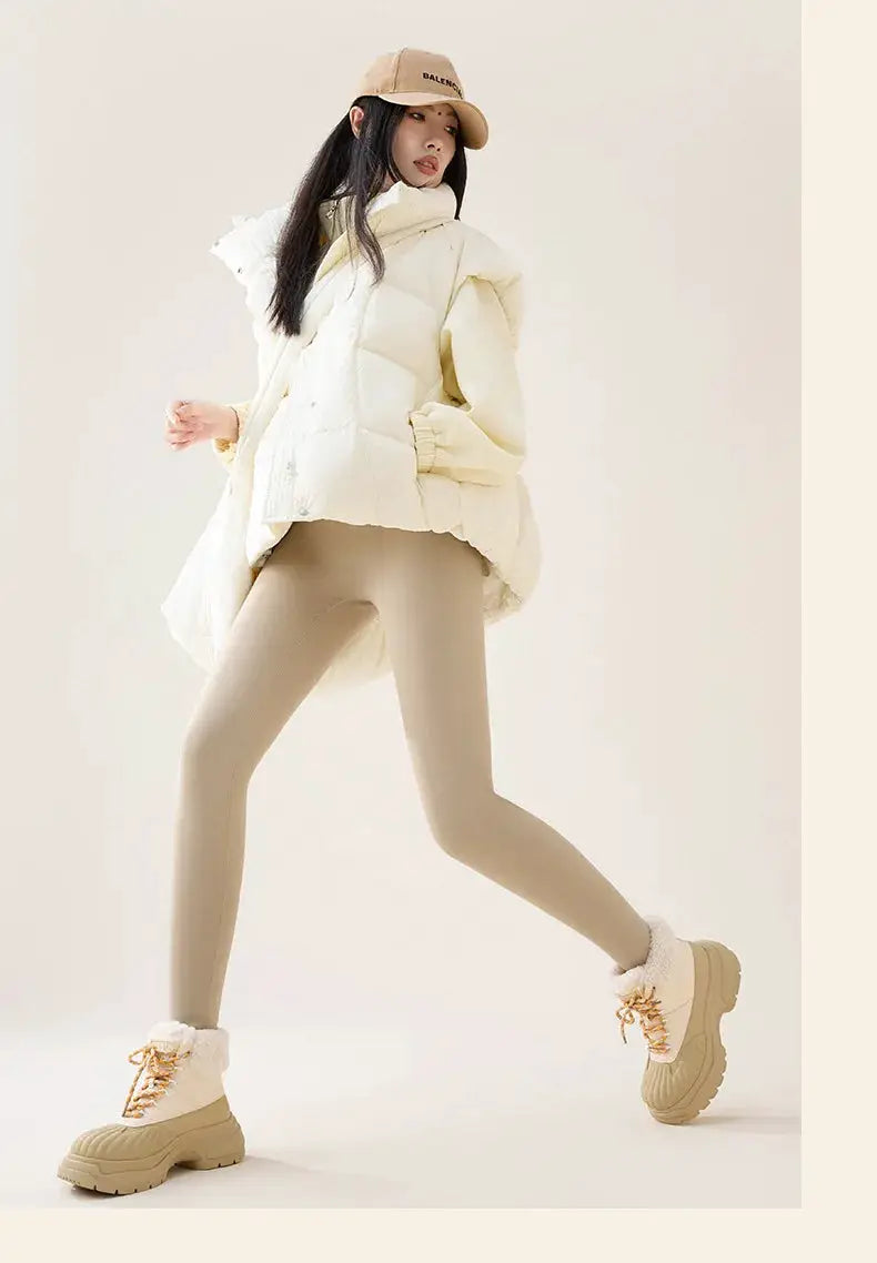 BIVIGAOS high-waist fleece sharkskin leggings in beige; model wears cream puffer jacket and tan boots, Balenciaga cap.