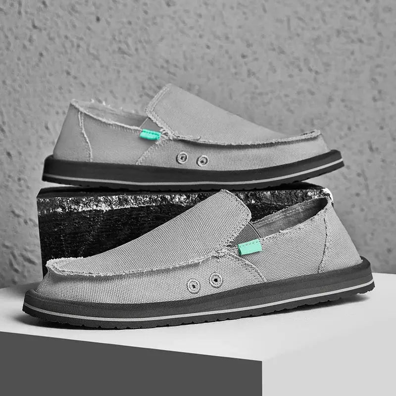 Men's canvas loafers; light gray fabric with mint green accents and black sole, pair shown