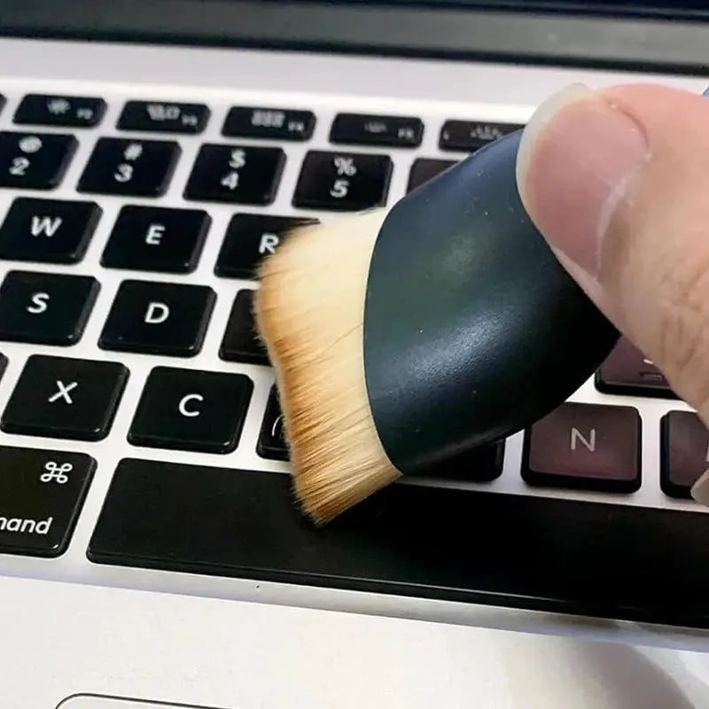 Keyboard cleaning brush with thick soft beige fur and dark handle for dust and crevices.