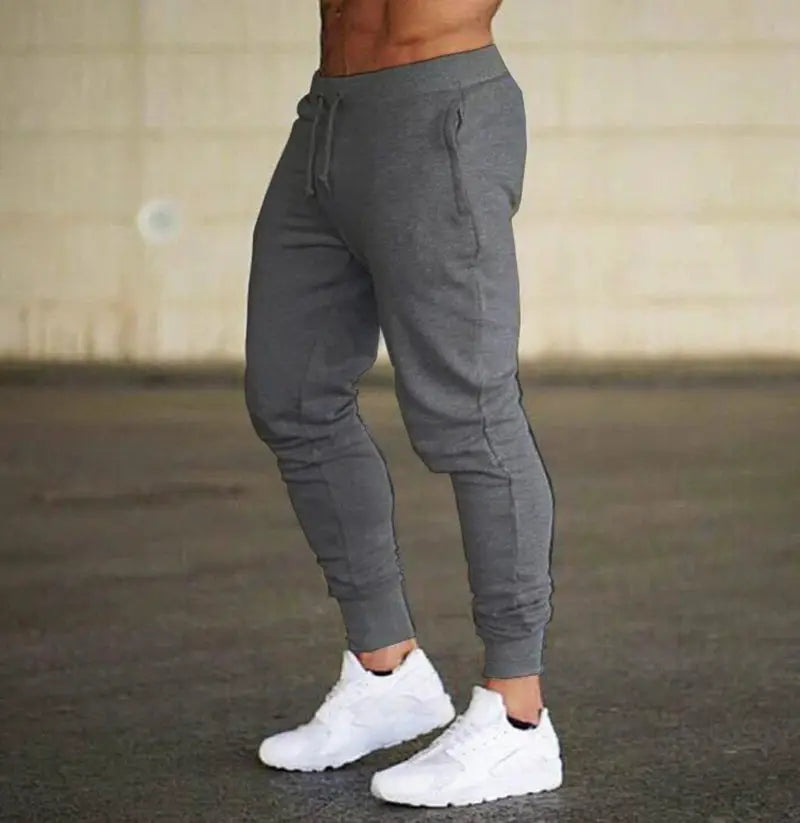 Men's gray jogger pants with drawstring waist, loose straight leg and side pockets
