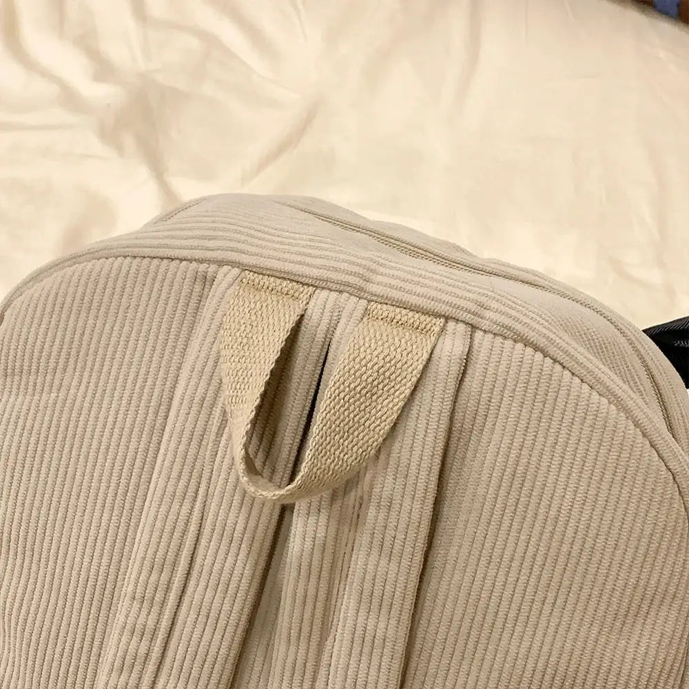 Beige corduroy backpack with top carry loop, casual commuter college bag