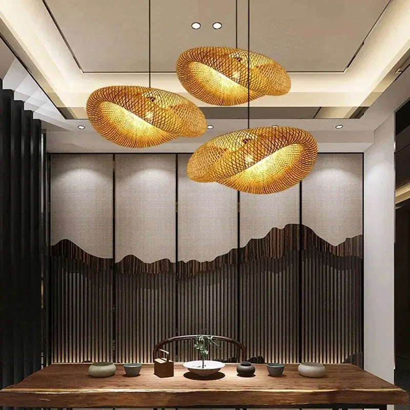 Bamboo weaving LED pendant lights set of three with warm amber glow over a wooden dining table