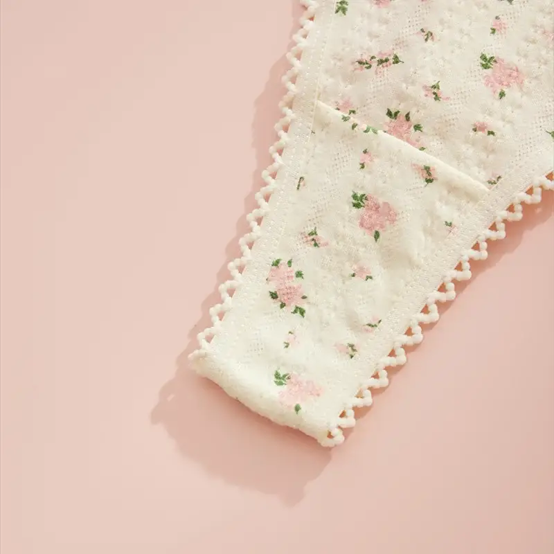 Cream floral print thong underwear for women with decorative pom-pom trim