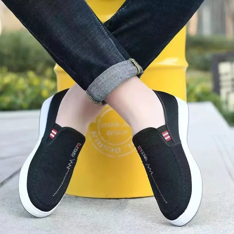 Men's black breathable canvas slip-on sneakers with white soles