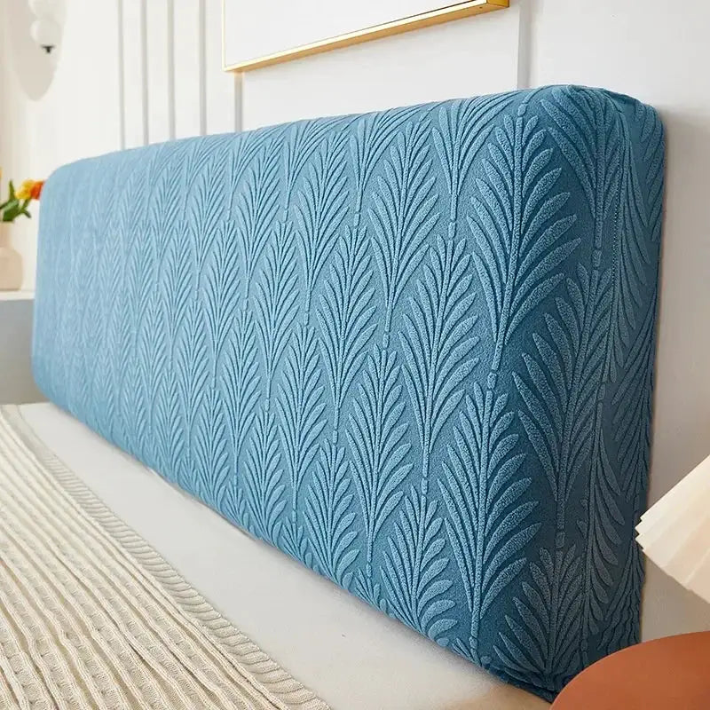 Headboard slipcover in teal blue jacquard with leaf pattern; elastic backrest cover by Simples Market