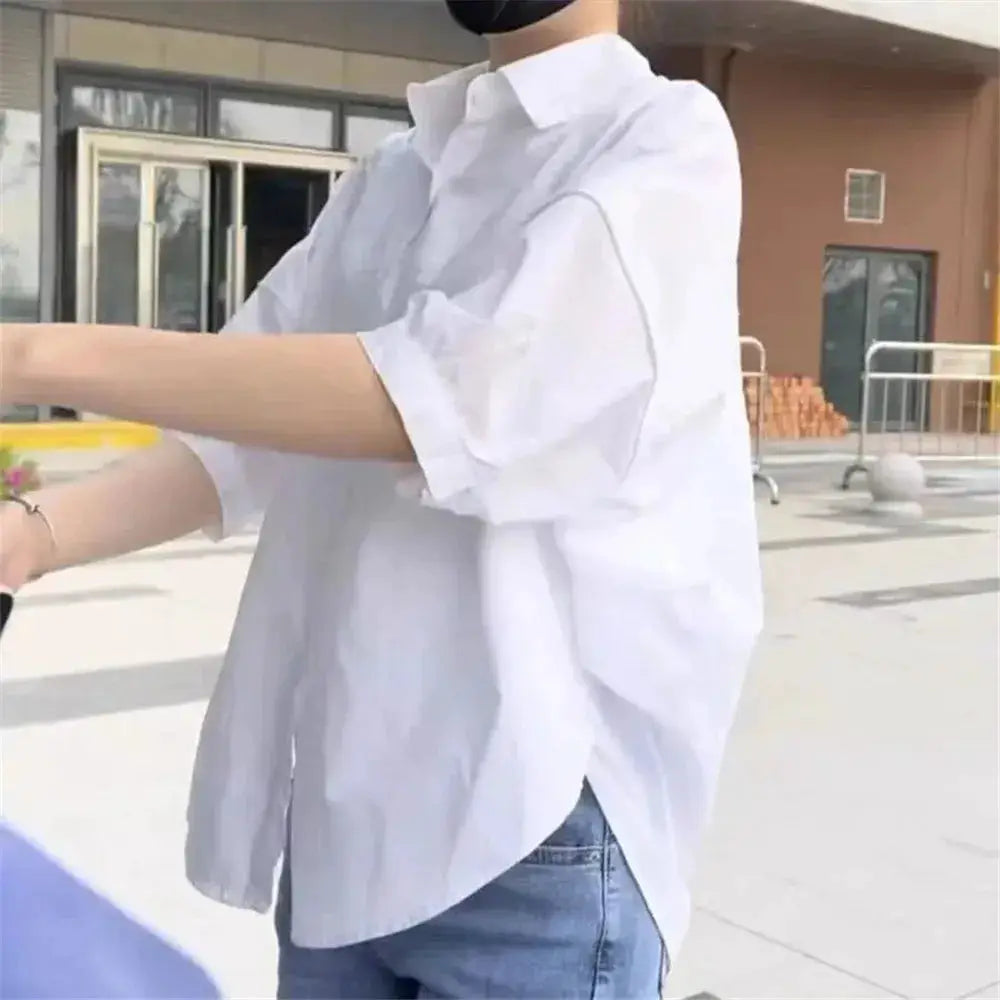 White oversized women's blouse with mid-length sleeves, casual loose-fit shirt.