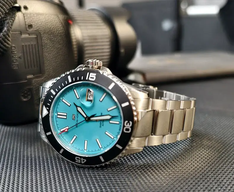 Seagull diving men's watch with turquoise dial, black bezel, and stainless steel bracelet