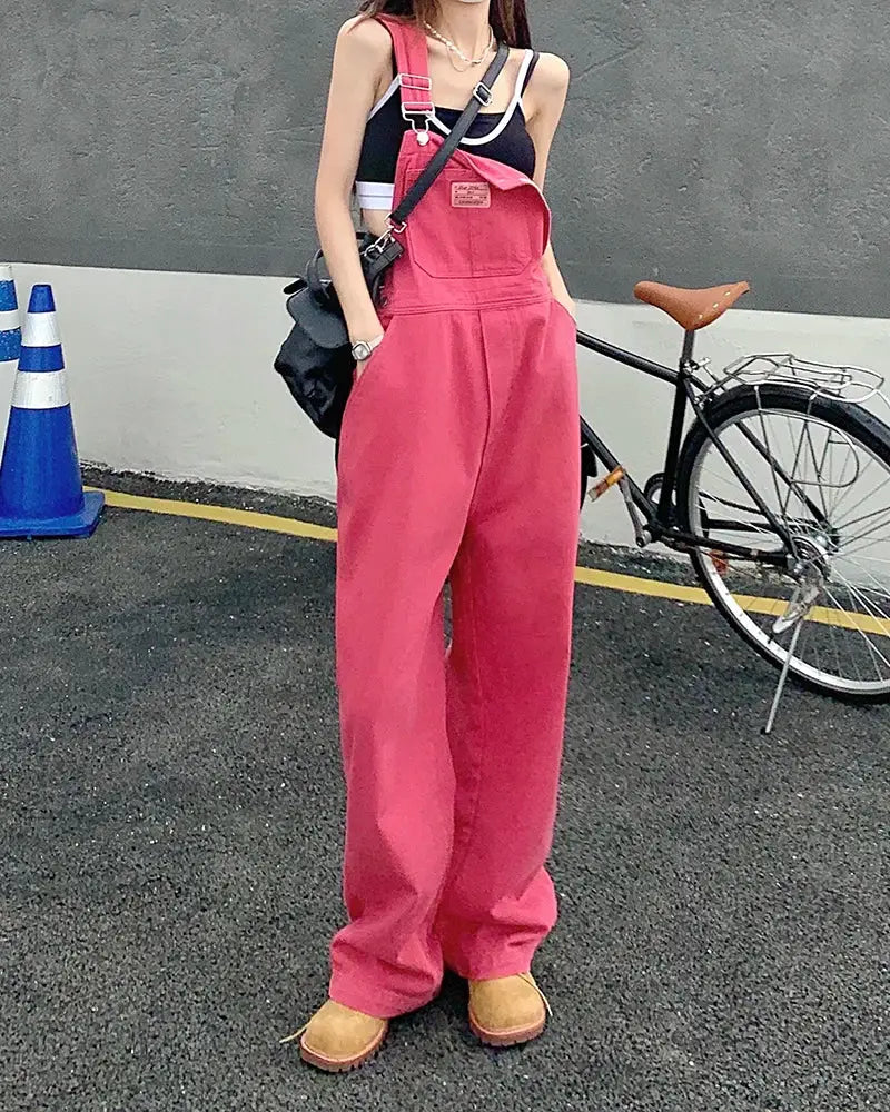 Pink women's wide-leg denim overalls with bib straps, loose casual jumpsuit