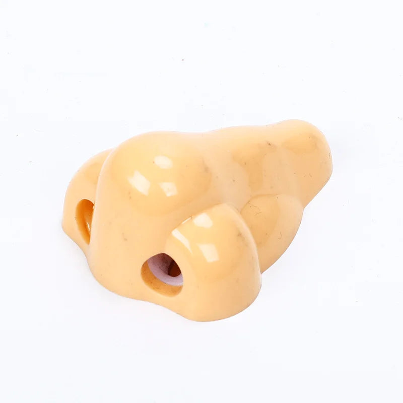 Nose-shaped pencil sharpener, beige plastic, Simples Market novelty school supply.