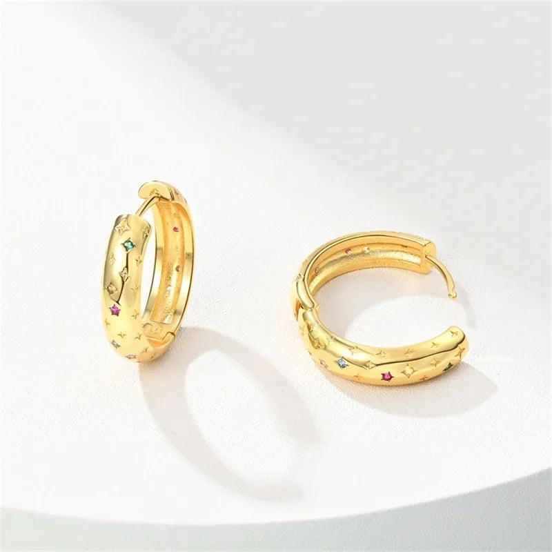 Gold-tone pair of hoop earrings with star and moon accents and colorful stones Simples Market