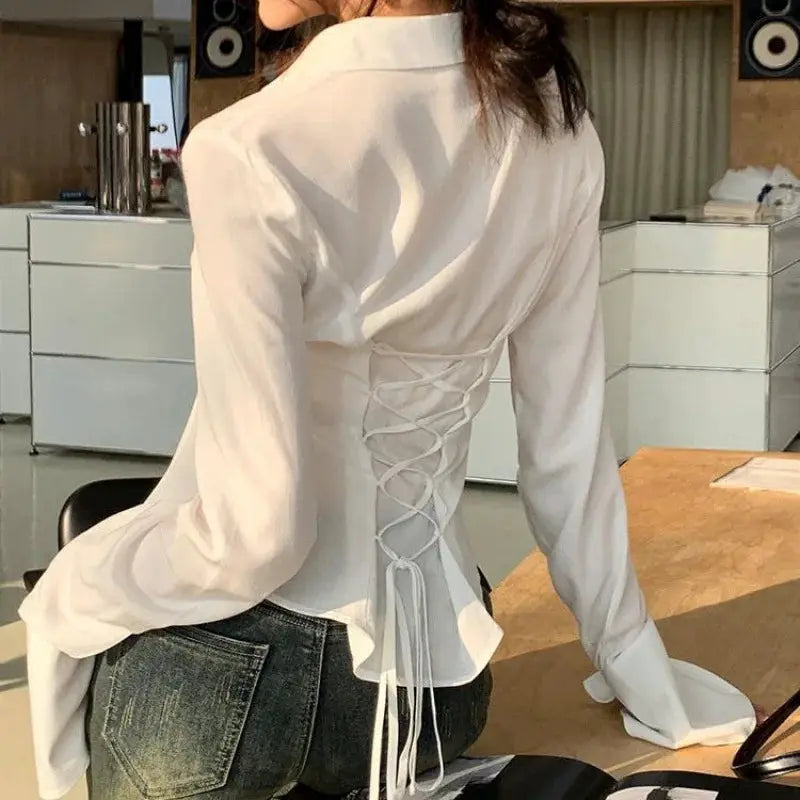 White bandage blouse with corset lace-up back, long bell sleeves, casual streetwear style.