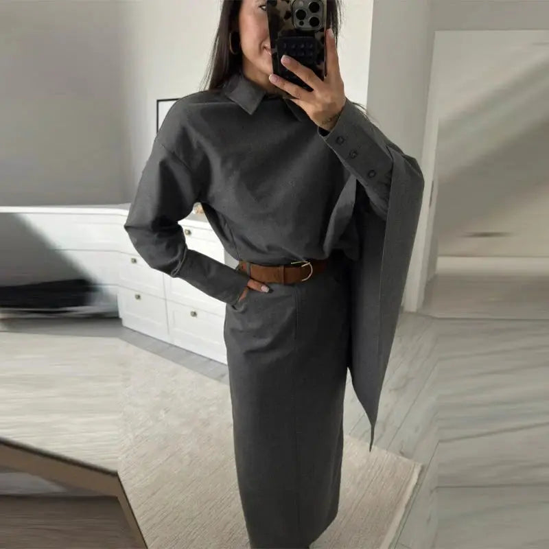 Grey women's blazer suit set with polo neck cape blouse and long pencil skirt, belted at waist