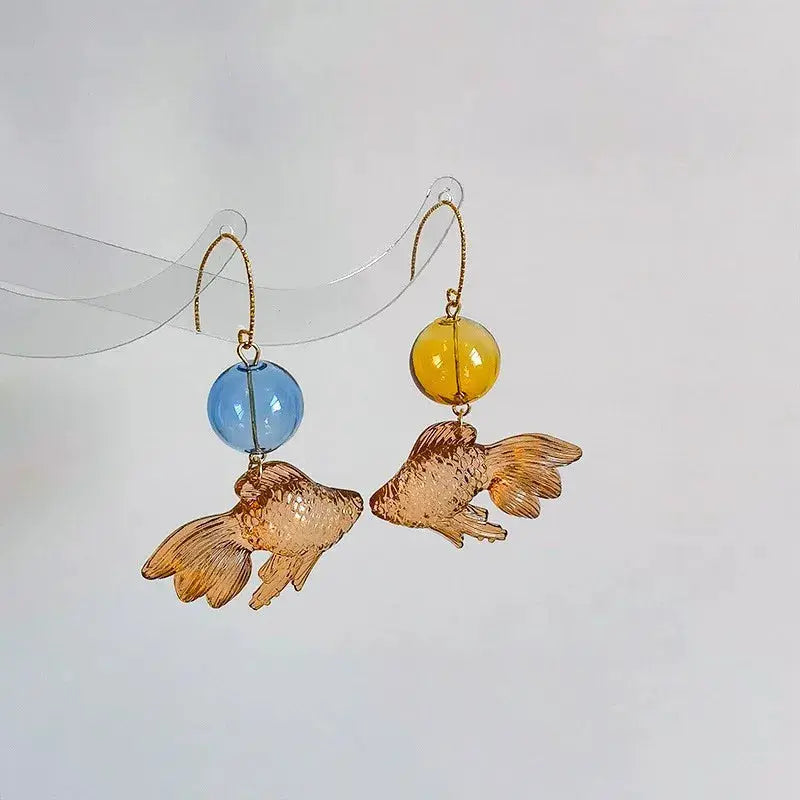 Goldfish drop earrings by Simples Market, two earrings with transparent blue/yellow beads and gold-tone koi pendants