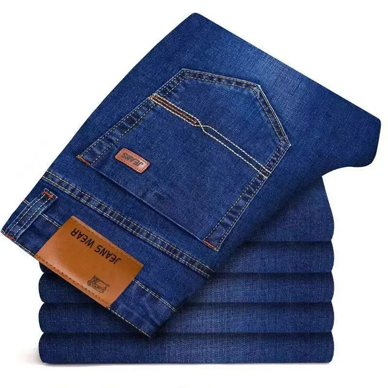 Men's blue denim jeans, set of 5 stacked; back pocket features brown leather patch.