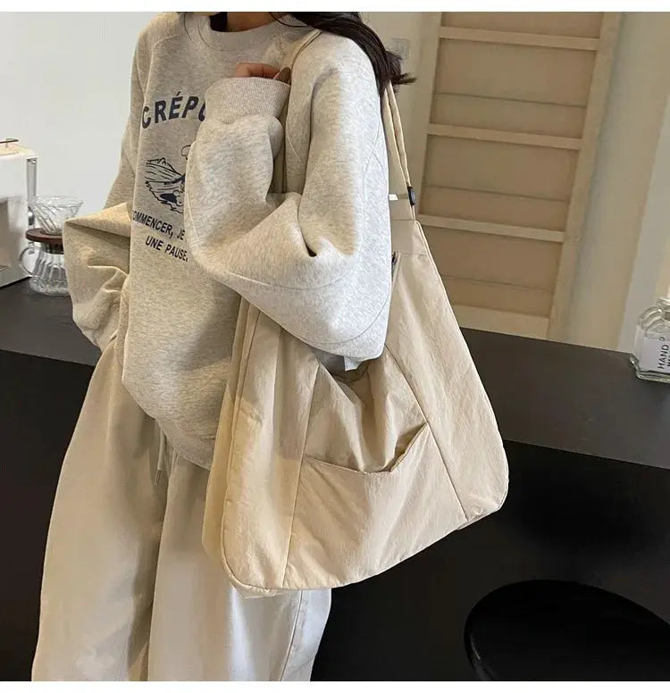Beige soft-cloth women's shoulder bag with a long strap, large tote style