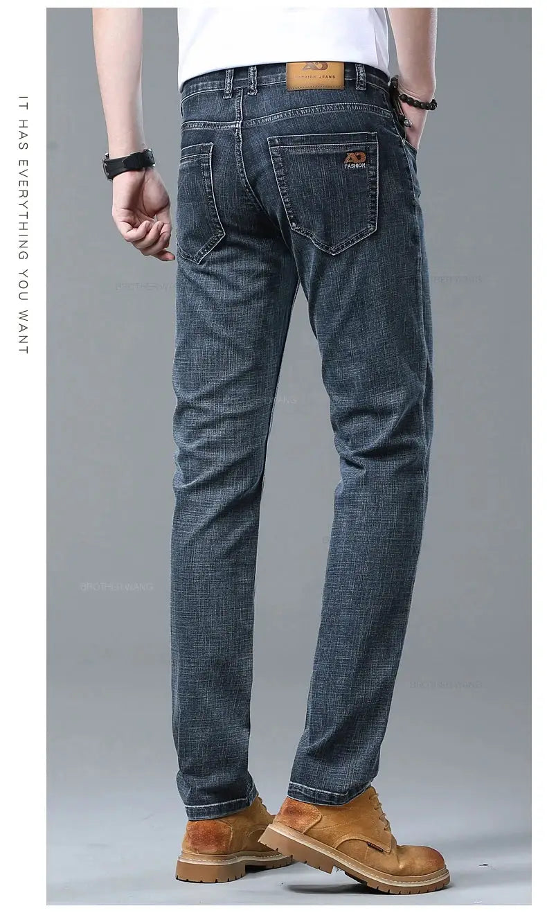 Men's slim-fit dark blue denim jeans with back pockets and a leather waistband patch
