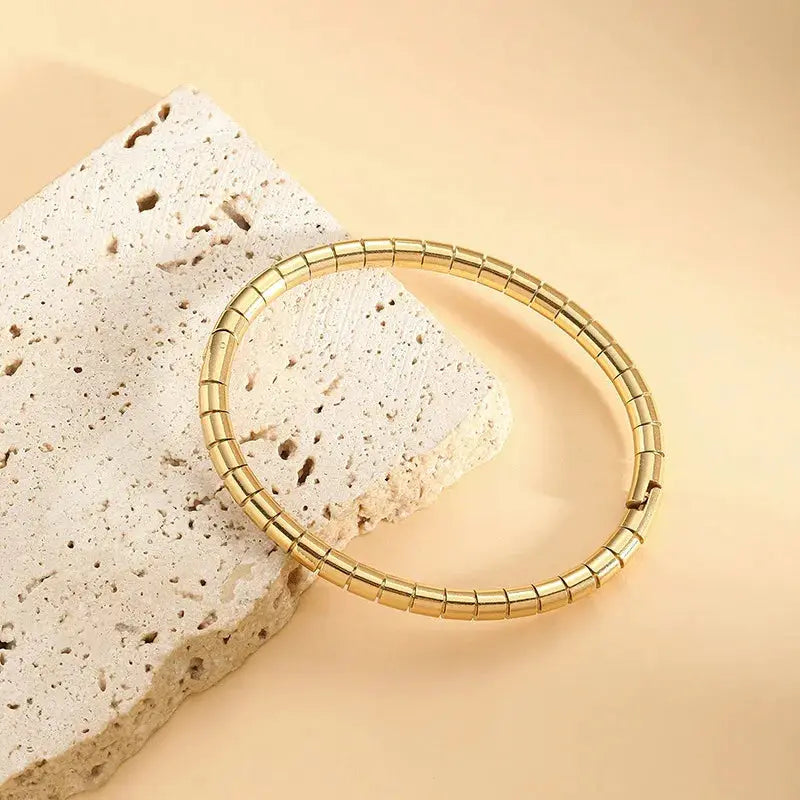 ZAKOL gold stainless steel cuff bracelet for women, openable with smooth segmented design.